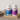 Two bottles of Conceive Plus fertility support supplements on a wooden tray with a neutral background.