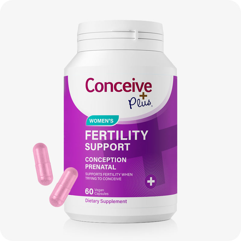 Front Image of the Conceive Plus Women Fertility Support US Bottle on a white background with two pink capsule at the lower left corner