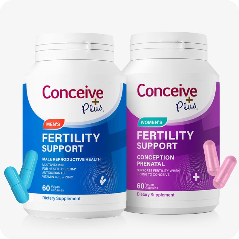 Conceive Plus Fertility Support Him & Her Bundle featuring two supplement bottles on a white background. The Men’s Fertility Support bottle is on the left with two turquoise capsules near the lower left, and the Women’s Fertility Support bottle is on the right with two pink capsules near the lower right, representing a complete couple’s fertility support solution.